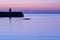 Spectacular early morning view of West Pier lighthouse of famous Dun Laoghaire harbor during the blue hour before sunrise, Dublin