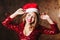 Spectacular girl in red sparkle dress dancing at christmas party. Close-up portrait of charming female Santa Claus