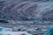 Spectacular glacier tongue end over icebergs lake