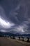 Spectacular gray cumulonimbus clouds above sea during dawn light