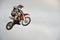 The spectacular jump moto racer on a motorcycle