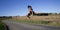 Spectacular jump of a woman over a country road.