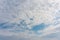 Spectacular light altocumulus clouds on the sky on a summer day. Natural background