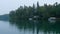 Spectacular Minnesota lake shore with cabins and water craft in evening clip.