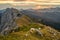 Spectacular mountain view of sun rising above high ridge in the distance.