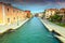 Spectacular narrow canal with old buildings in Venice, Italy, Europe