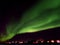 Spectacular northern lights flashing over a small town of northern Iceland