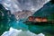 Spectacular romantic place with typical wooden boats on the alpine lake,(Lago di Braies) Braies lake