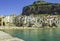 Spectacular scenic view of Cefalu` port, characteristic white houses, clear water and beach in Sicily