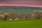 A spectacular show of colors during the sunrise in the rolling hills of the Netherlands over the village of Epen, in the Heuvellan