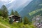 Spectacular summer alpine landscape, mountain swiss wooden chalet with high mountains in background, Zermatt