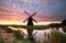 Spectacular sunrise over farmland with windmill
