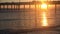 Spectacular sunset beyond the Venice Pier crowded with silhouetted tourists