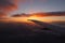 Spectacular sunset from inside an airplane over clouds