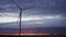 Spectacular sunset with modern wind turbines in slow-mo