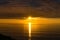 Spectacular sunset over sea with vivd golden colores of water an