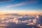 Spectacular Sunset Skies: Captivating Aerial Views of Dramatic Clouds from an Airplane.