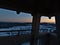 Spectacular sunset view over Black Forest with Alps on horizon from the top of observation tower with binoculars in winter.