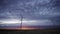 Spectacular sunset with windmills rotating, worms eye view