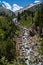 Spectacular vertical view river with large stones coming down from a waterfall in the Aragonese Pyrenees of Benasque. Mountains