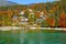 Spectacular view of lakefront holiday houses hiding in the autumn colored woods