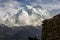 Spectacular view of Mount Annapurna II with a Nepali man in the foreground and a typical house during the Annapurnas round trek