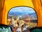 Spectacular view of nature from open tent entrance. The beauty of romantic trekking and camping