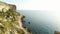 Spectacular view of steep dliffs at the ocean, Ireland. Shot. Green slope near calm water and the endless horizon on