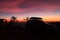 Spectacular vivid purple sunset and car silhouetted