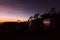 Spectacular vivid purple sunset and car silhouetted