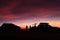 Spectacular vivid purple sunset and car silhouetted