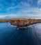 Spectacular volcano cliffs with red layers over volcanic coastline