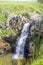 Spectacular water flow over the basalt canyon rocks and Iris Waterfall in the Golan heights