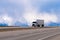 Spectacular white semi truck trailer reefer on highway in snow m