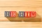 Spectacular wooden cubes with the word HE HIM on a wooden surface