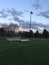 Spectator benches: soccer field at dusk in early spring