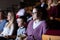 Spectators eating popcorn and watching a movie at cinema