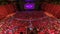 Spectators gather in the auditorium and watch the show in theatre timelapse. Large hall with red armchairs seats