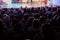 Spectators at a theater performance, in a cinema or at a concert. Shooting from behind. The audience in the hall