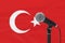 Speech Microphone Stand Against of Blurred Turkish Flag. 3d Rendering