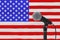 Speech Microphone Stand Against of Blurred USA Flag. 3d Rendering