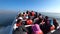 Speed boat full of tourists sailing towards Ballestas island to watch birds and natural life, Peru