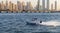 Speed boat i the waters of Dubai Marina. City