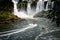 Speed boat rides under the water cascading over the Iguacu falls