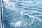 Speed boat with white wake stream in blue sea water. Side view. Travel Concept. Vacation