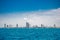 Speed boats and city buildings near the sea, sky and clouds