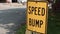 speed bump caption text writing rectangle metal sign with still parking lot