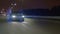 Speed car drives along highway at cold dark winter night