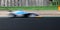 Speed concept blurred motion racing car asphalt track side view