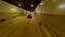 Speed flight follow movement FPV drone aerial view dark tunnel with fast driving red sport car